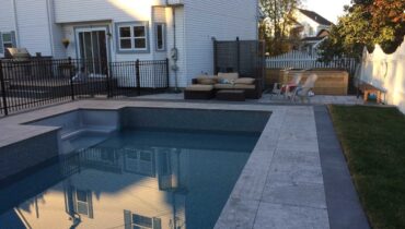 Fiberglass pool installation in residential backyard with modern landscaping
